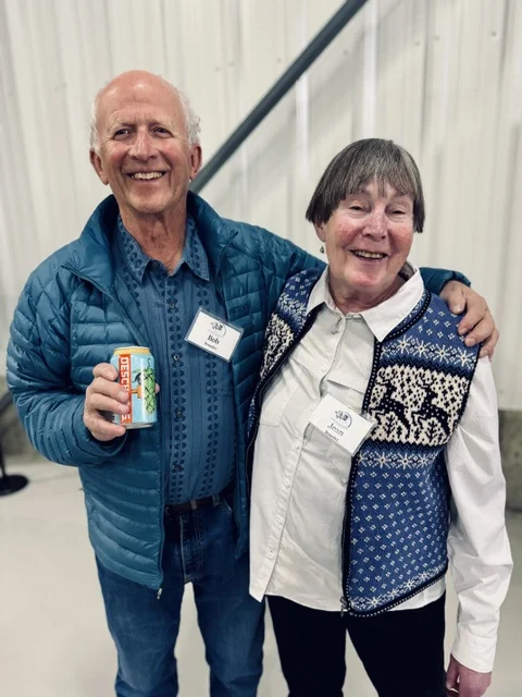 Bob and Jean Benedict, founding Tin Cup Challengers, smiling at a Community Foundation event