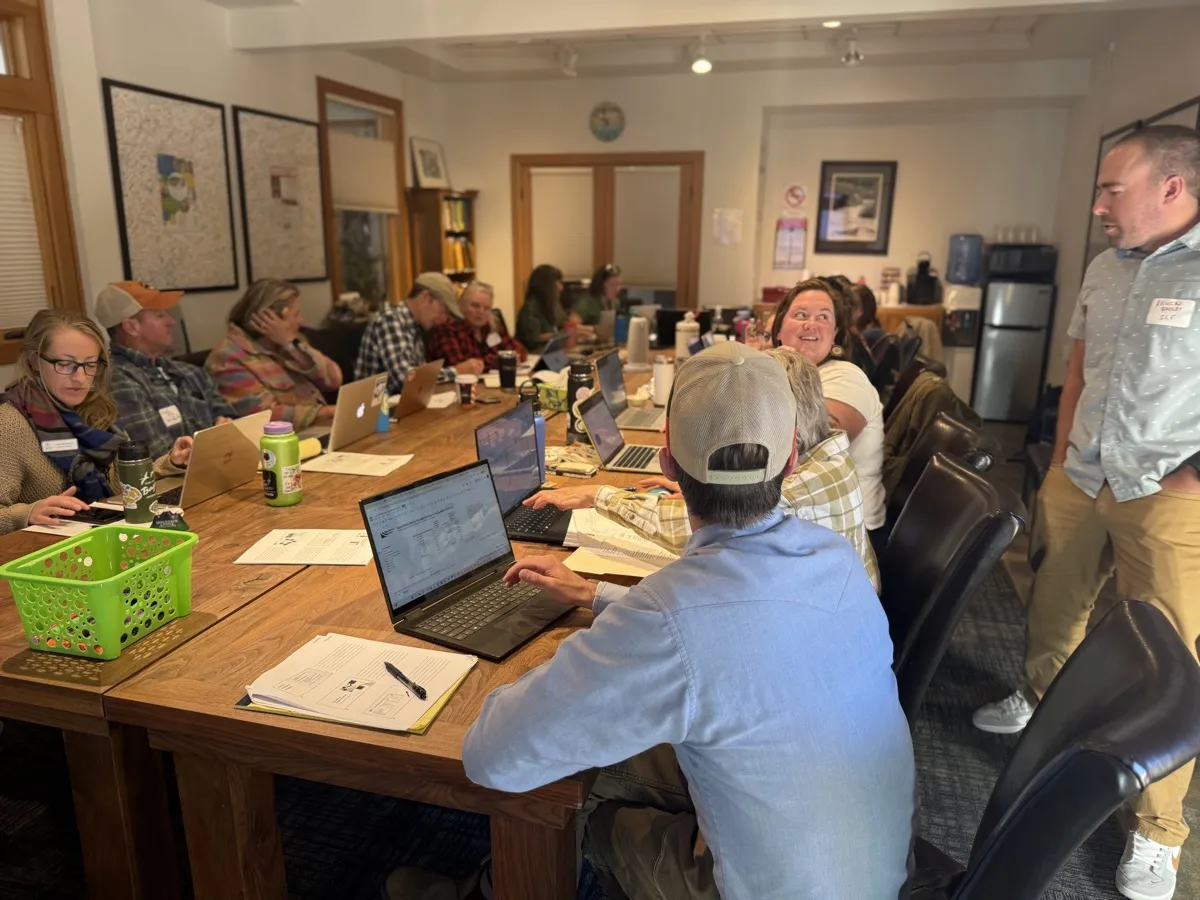 Nonprofit leaders with laptops working together at a Community Foundation workshop table